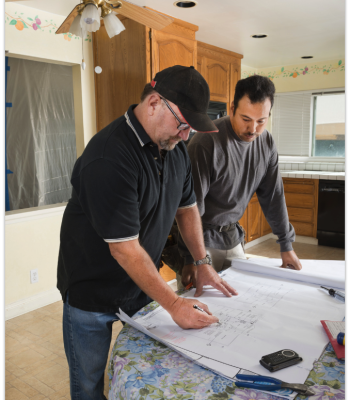 Construction Workers Reviewing Bathroom Remodel Plans